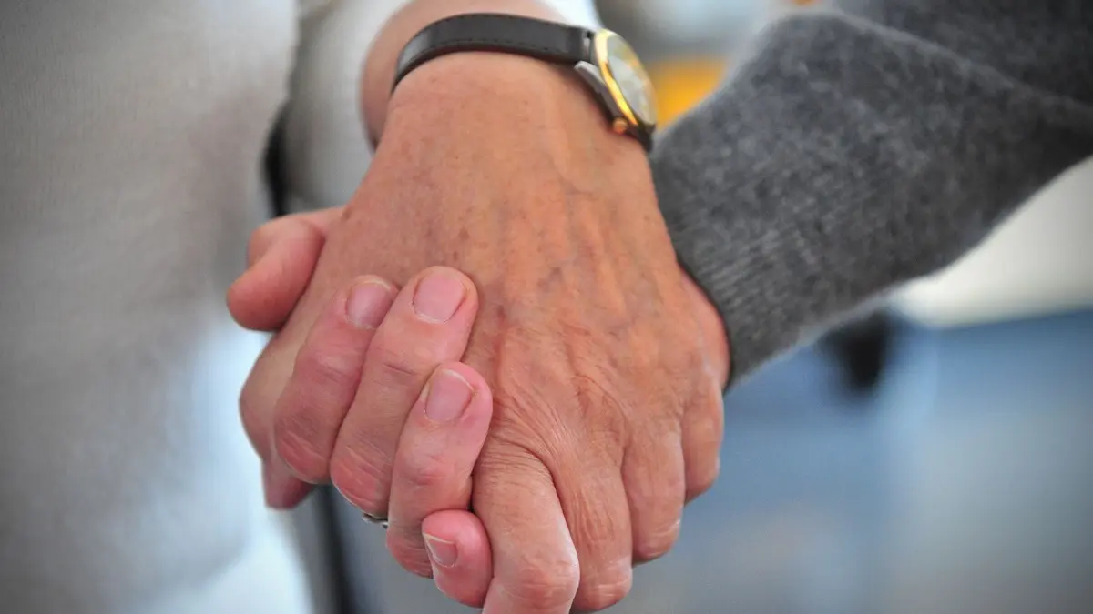 Die ehrenamtliche Helferin Ilse Danneil (l), hält am 26.10.2012 im Hospiz St. Martin in Stuttgart (Baden-Württemberg) die Hand einer Frau. Mehr als 6 000 ehrenamtliche Mitarbeiter im Südwesten leisten als Sitzwache Sterbebegleitung. Foto: Jan-Philipp Strobel/dpa ( zu lsw "Niemand muss alleine sterben - Sitzwache im ambulanten Hospizdienst" vom 31.10.2012) +++(c) dpa - Bildfunk+++