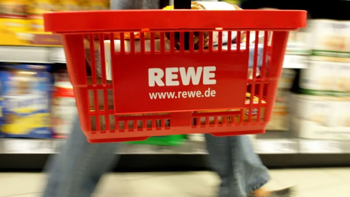 Der Handeslriese hat die Zusammenarbeit mit dem Deutschen Fußballbund (DFB) beendet. (Symbolbild)
ARCHIV - Eine Kundin mit einem tragbaren Plastikkorb mit REWE-Logo am Arm kauft ihre Lebensmittel in einem REWE-Supermarkt in Köln ein (Archivfoto vom 19.01.2007). Computerhacker sind auf der Suche nach Kundendaten in das Netzwerk des Handelskonzerns Rewe eingedrungen. Mit einem illegalen Angriff versuchten Unbekannte, aus zwei Datenbanken Kundeninformationen auszulesen, berichtete das Unternehmen am Sonntagabend. Foto: Rolf Vennenbernd dpa +++(c) dpa - Bildfunk+++