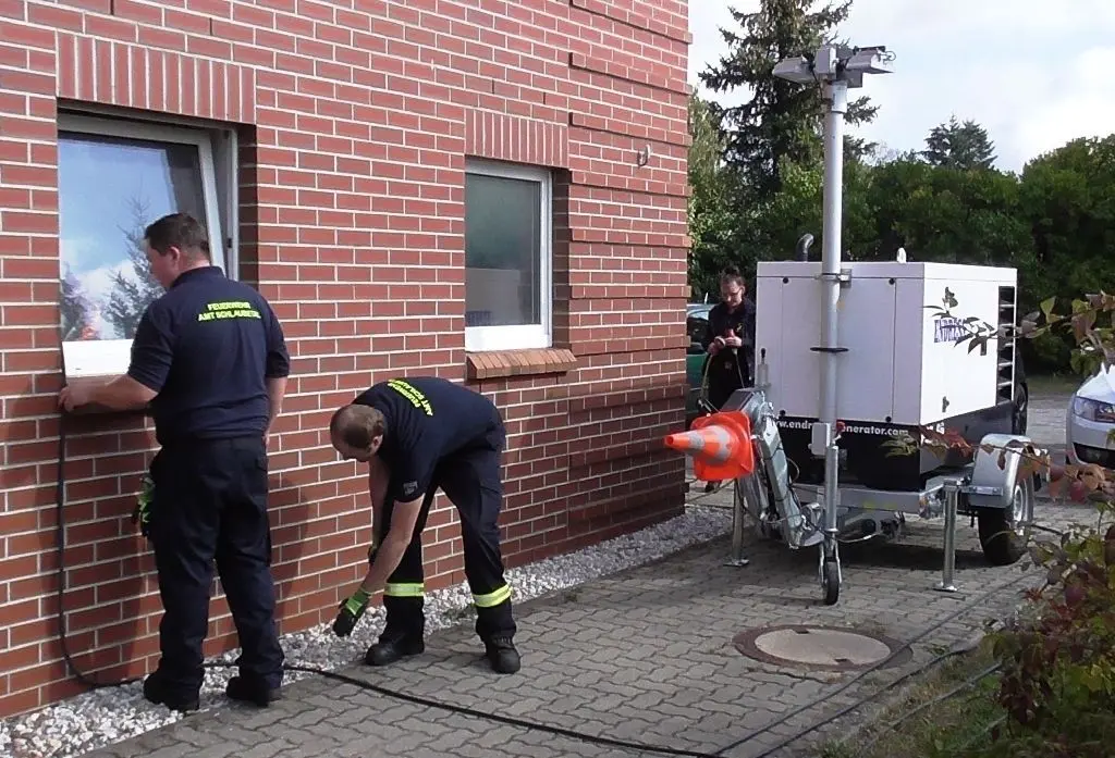 Gerätehaus noch ohne Strom: Müllroser Feuerwehrleute nehmen den leistungsstarken Stromerzeugeranhänger in Betrieb.