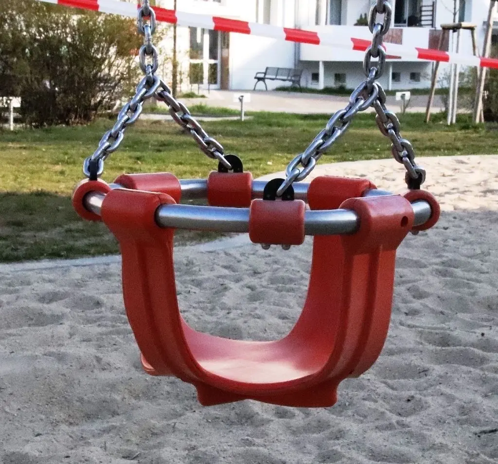 Auch an die Kinder wurde gedacht: Schaukelsitz auf dem Spielplatz, auf dem mehrere Spielgeräte stehen