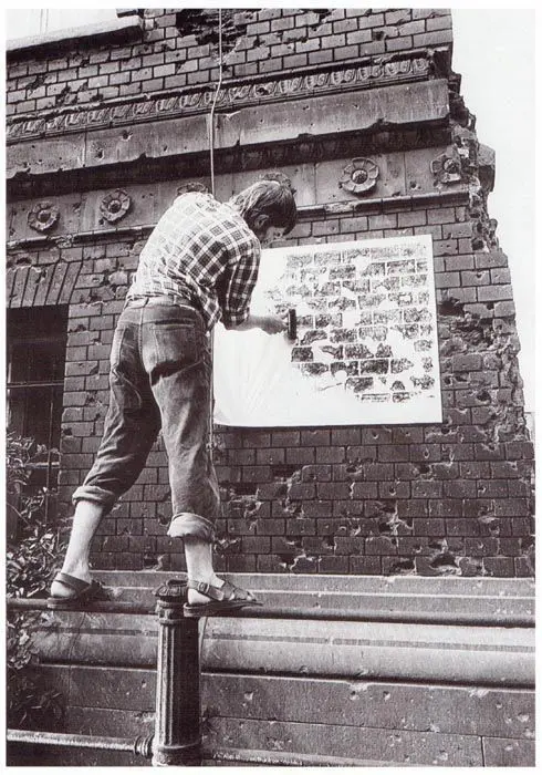 Manfred Butzmann bei der Abreibung von 1945 zerschossenem Mauerwerk, Clara-Zetkin-Straße, 19. Juli 1989 Berlin
