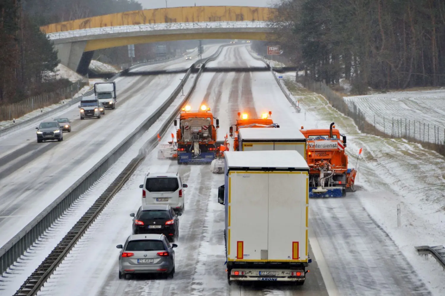 Eeine sogenannte Räum-Staffel der Autobahnmeisterei Fürstenwalde rückt auf der A12 vor. Drei Fahrzeuge mit mächtigen Schneepflügen bewegen sich versetzt.