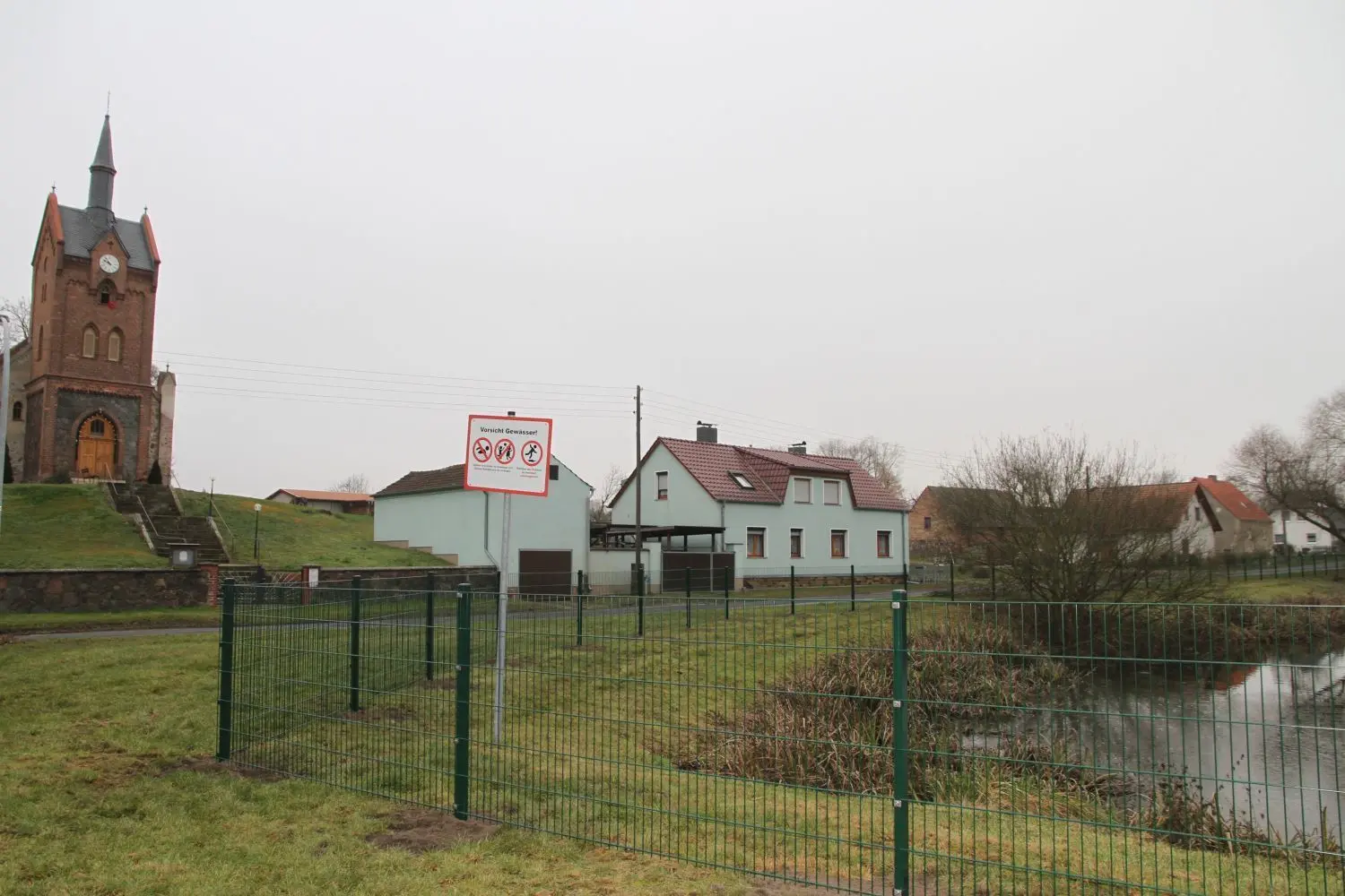 Sorgte auch im Amtsausschuss für Diskussionen: Der Dorfteich im Neuhardenberger Ortsteil Wulkow ist neuerdings umzäunt. Er ist für den Brandschutz als Löschteich deklariert worden. Die Baumaßnahme trübt nun den freien Blick zwischen Schloss und Kirche.