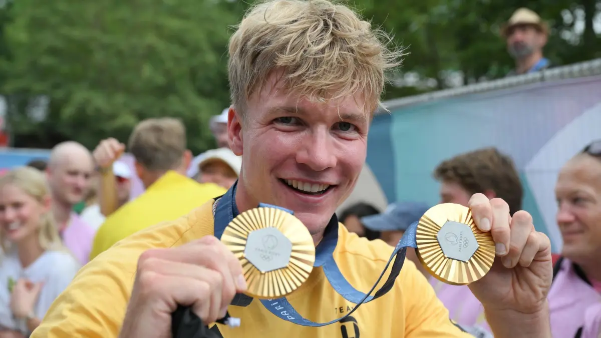 Paris 2024 - Kanu: 09.08.2024, Frankreich, Vaires-Sur-Marne: Olympia, Paris 2024, Kanu, Kajak-Zweier, 500 m, Herren, Finale, Deutschlands Jacob Schopf hält seine beiden Goldmedaillen in den Händen. Foto: Sebastian Kahnert/dpa +++ dpa-Bildfunk +++