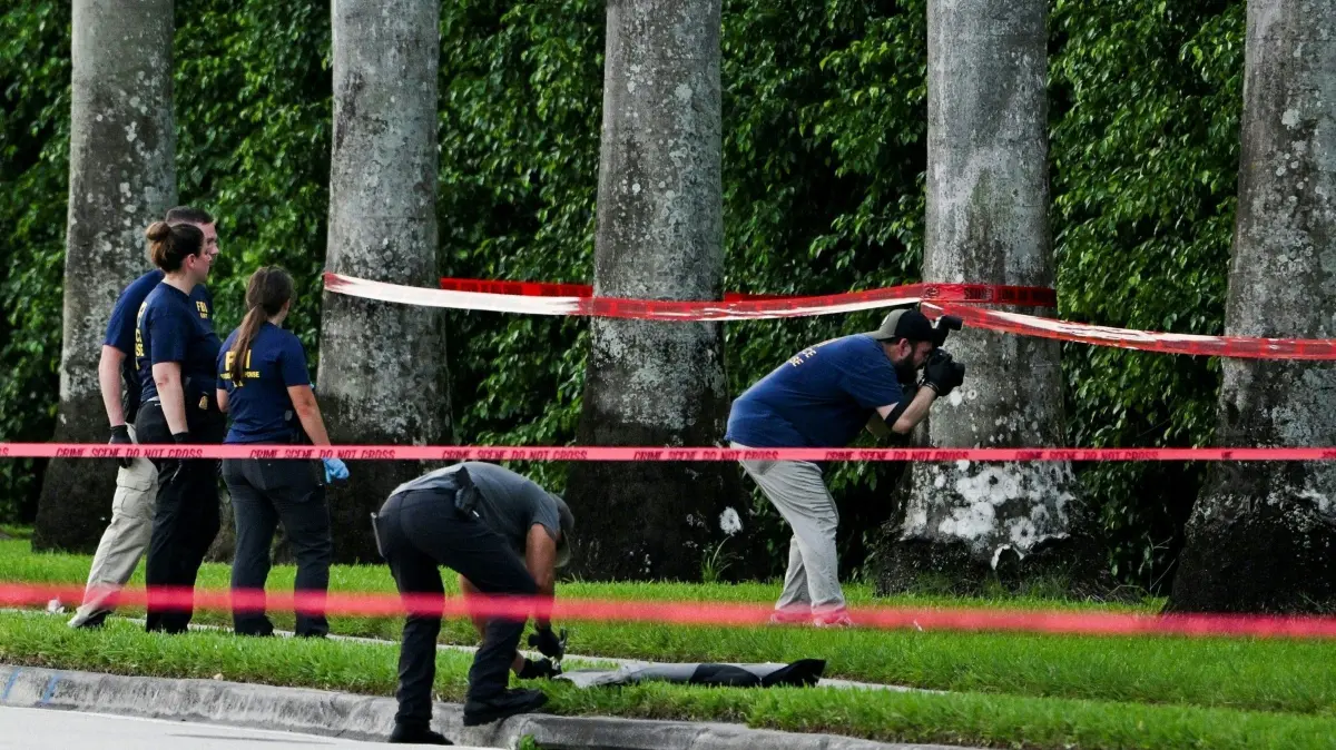 Members of FBI are seen at the crime scene outside the Trump International Golf Club in West Palm Beach, Florida, on September 15, 2024 following a shooting incident at former US president Donald Trump's golf course. Trump's campaign reported Sunday that there had been "gunshots in his vicinity" but added that the Republican presidential candidate was safe. (Photo by CHANDAN KHANNA / AFP)