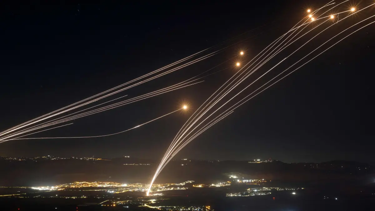 -- AFP PICTURES OF THE YEAR 2024 --
Rockets fired from southern Lebanon are intercepted by Israel's Iron Dome air defence system over the Upper Galilee region in northern Israel, on August 4, 2024, amid ongoing cross-border clashes between Israeli troops and Lebanon's Hezbollah fighters.. Middle East tensions soared Saturday as Iran and its allies readied their response to the assassination of Hamas's political leader, blamed on Israel, spurring fears of a regional war. (Photo by Jalaa MAREY / AFP) / AFP PICTURES OF THE YEAR 2024