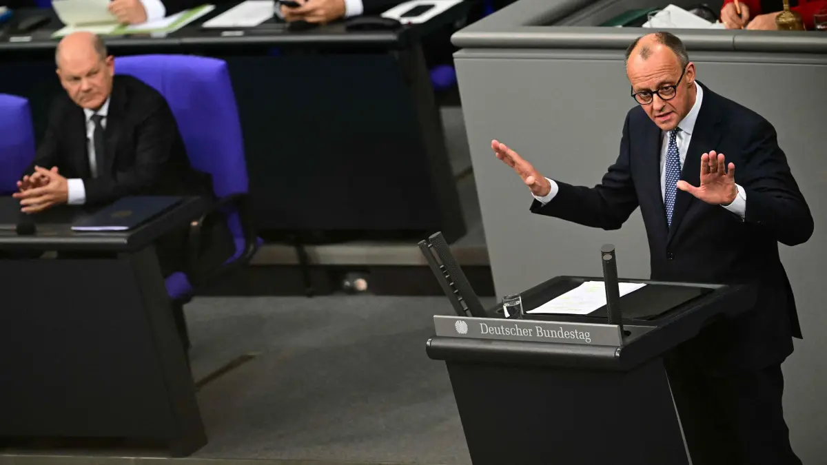 Leader of Germany's Christian Democratic Union (CDU) Friedrich Merz gestures as he addresses the Bundestag (Lower house of Parliament) in Berlin on December 16, 2024, ahead of a no-confidence vote against German Chancellor Olaf Scholz (R). Germany's embattled Chancellor Olaf Scholz faces parliament on December 16, 2024 to trigger the process towards February 23, 2025 elections, in the hope that he can weather a political crisis and win a second term. (Photo by Tobias SCHWARZ / AFP)