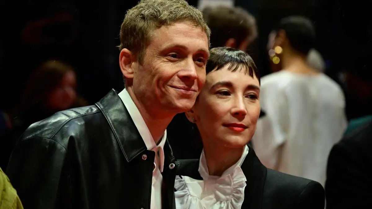 776282771: German actor Matthias Schweighoefer and German actress Sibel Kekilli pose for photographers as they arrive on the red carpet for the opening ceremony and the screening of the film ?Das Licht? (The light) in the "Berlinale special" section of the 75th Berlinale, Europe's first major film festival of the year, in Berlin on February 13, 2025. (Photo by John MACDOUGALL / AFP)