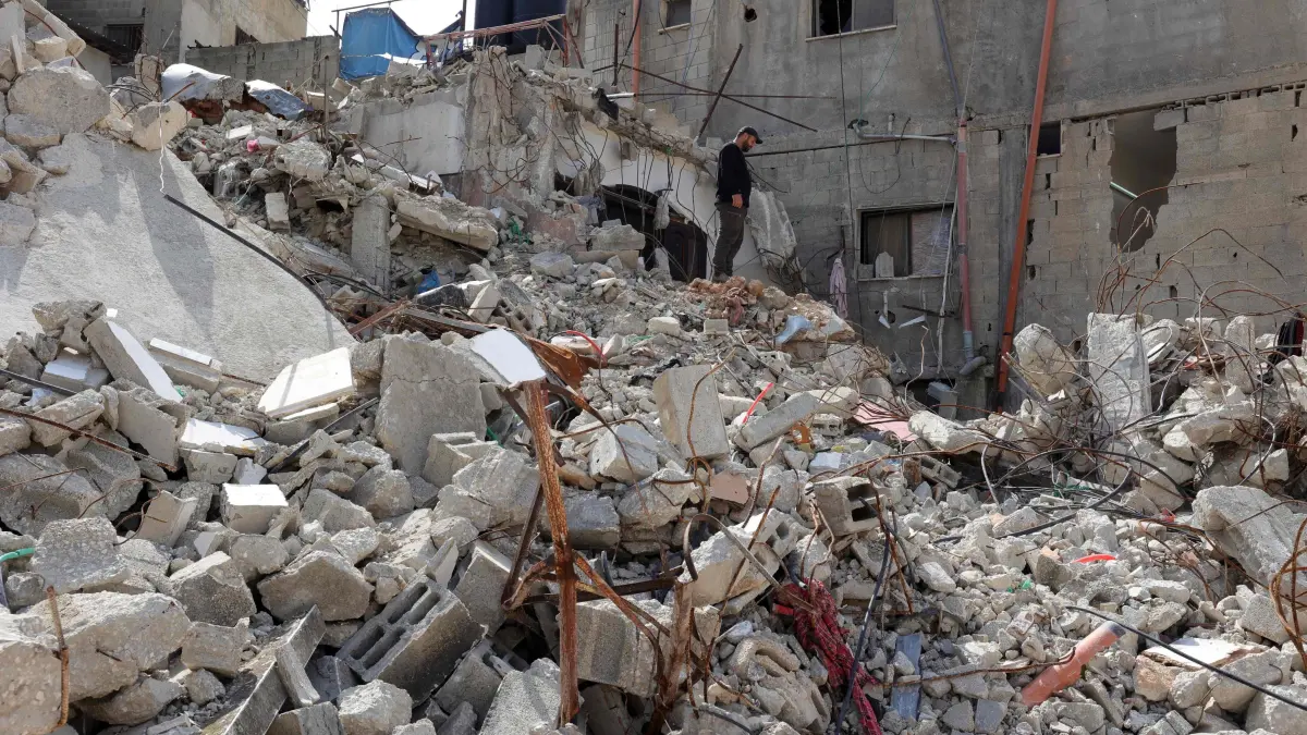 A man checks the devastation sin the Nur Shams camp for Palestinian refugees, in the occupied-West Bank on March 5, 2025. Israel launched a major military incursion in the occupied West Bank on February 21, two days after the Gaza ceasefire began. According to the UN, at least 55 Palestinians and three Israeli soldiers have died in the operation, which has displaced over 40,000 Palestinians, and in which the military has razed many homes. (Photo by Zain JAAFAR / AFP)