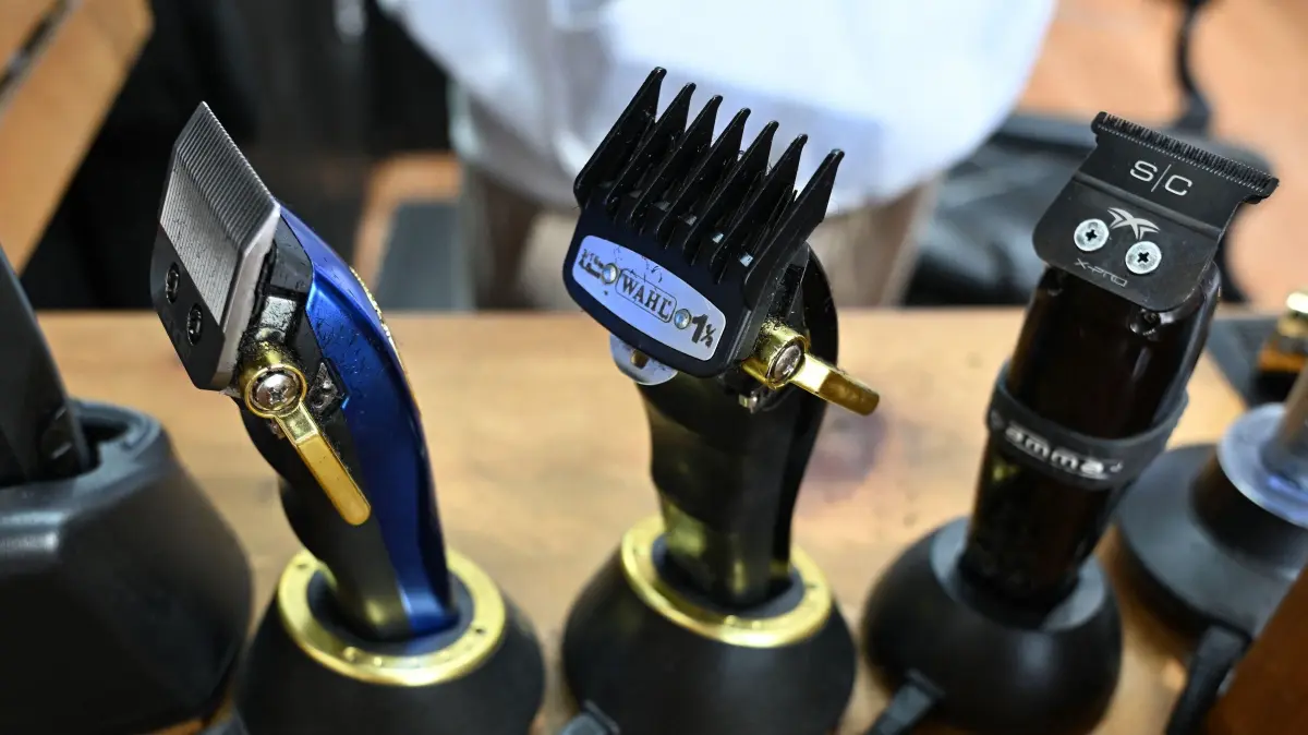 Some of the razors and shavers owner OJ Longmire uses at his Good Vibe Barbershop, in the San Fernando Valley area of Los Angeles, Califonria on April 16, 2025. The service sector is not immune either to US President Donald Trump's trade war, in which the president says he is fighting what he calls unfair trading practices from other countries and fighting back to erase trade deficits. OJ Longmire, 46 and owner of a popular barber shop and beauty parlor in the San Fernando Valley, says tariffs hurt him too. "It definitely affects us all. You know, supplies, everything here on my station. Clippers. I don't believe this is American made," he said, pointing to the equipment, gels and lotions he works with to do people's hair. (Photo by Robyn Beck / AFP)