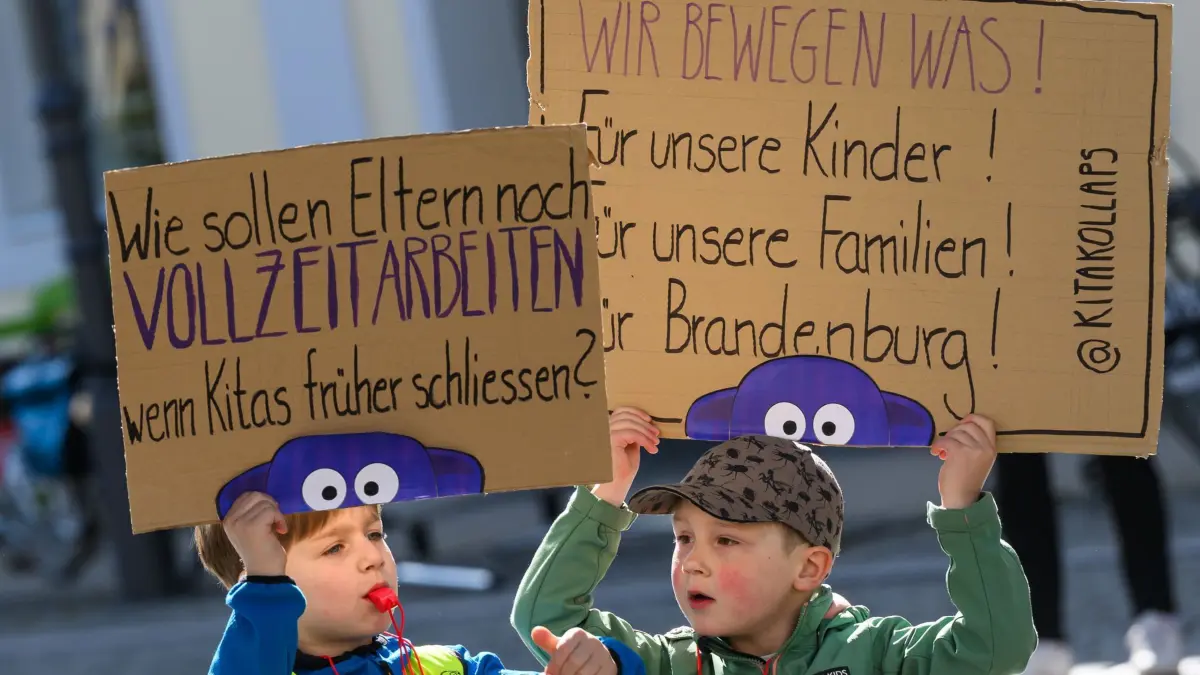 „Kita-Kollaps“ Aktionstag in Brandenburg: 15.05.2025, Brandenburg, Cottbus: Zwei Junge Teilnehmer am Aktionstag «Kita-Kollaps» protestieren auf dem Altmarkt in der südbrandenburgischen Stadt. Mit Aktionen in Potsdam und Cottbus will die Gewerkschaft Verdi auf die aus ihrer Sicht zu dünne Personaldecke an den Brandenburger Kindergärten aufmerksam machen. Im Rahmen eines Aktionstages «Kita-Kollaps» in Cottbus und Potsdam finden Demonstrationen statt. «Ziel ist es, auf die strukturellen Probleme in der Kindertagesbetreuung hinzuweisen und konkrete Verbesserungen einzufordern», hieß es in einer Verdi-Mitteilung. Foto: Patrick Pleul/dpa +++ dpa-Bildfunk +++