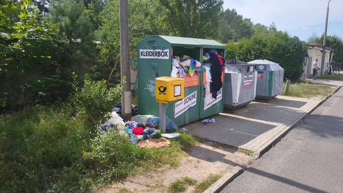 Ein überfüllter Altkleider-Container und Müllablagerungen in Eberswalde. An manchen Containern in der Gemeinde Schorfheide dürfte es ähnlich ausgesehen haben.