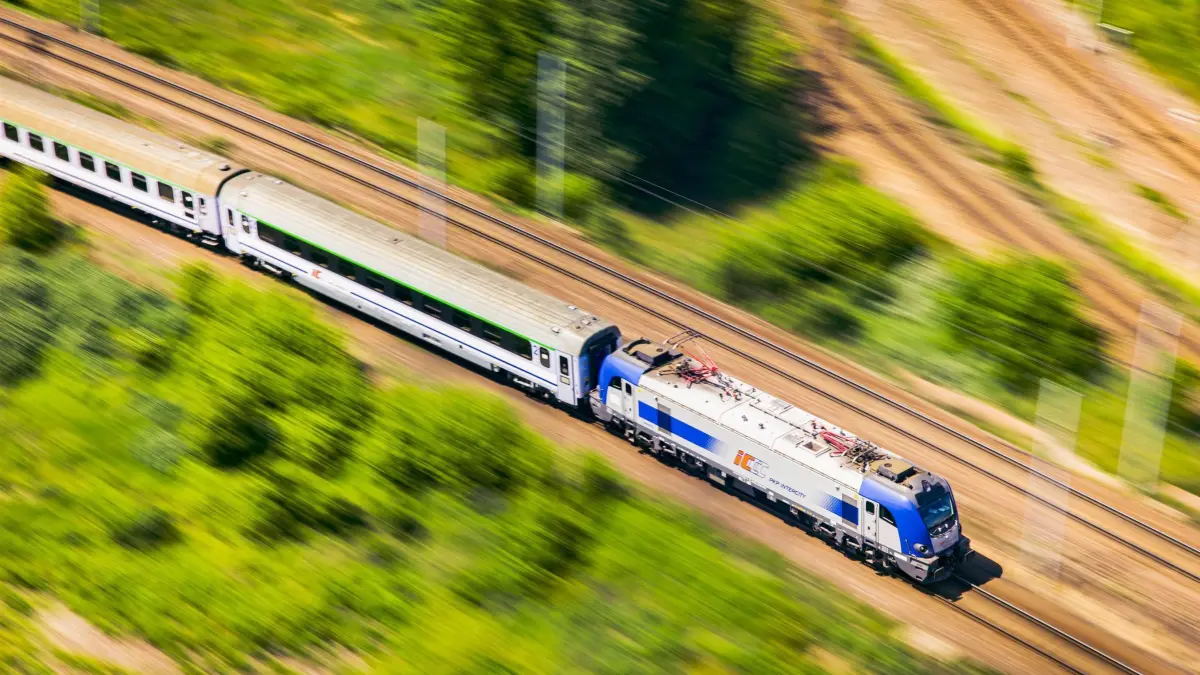 Eine polnischen Eisenbahn von PKP fährt durch die Landschaft: HANDOUT - Mit dem Zug nach Polen? Gut zu wissen: Diskretion und Höflichkeit haben hier Vorrang vor lauten Gesprächen oder Telefonaten. (zu dpa: «Europa per Zug: Tipps für beliebte Reiseländer») Foto: PKP Intercity/dpa-tmn - ACHTUNG: Nur zur redaktionellen Verwendung im Zusammenhang mit dem genannten Text und nur bei vollständiger Nennung des vorstehenden Credits - Honorarfrei nur für Bezieher des dpa-Themendienstes +++ dpa-Themendienst +++