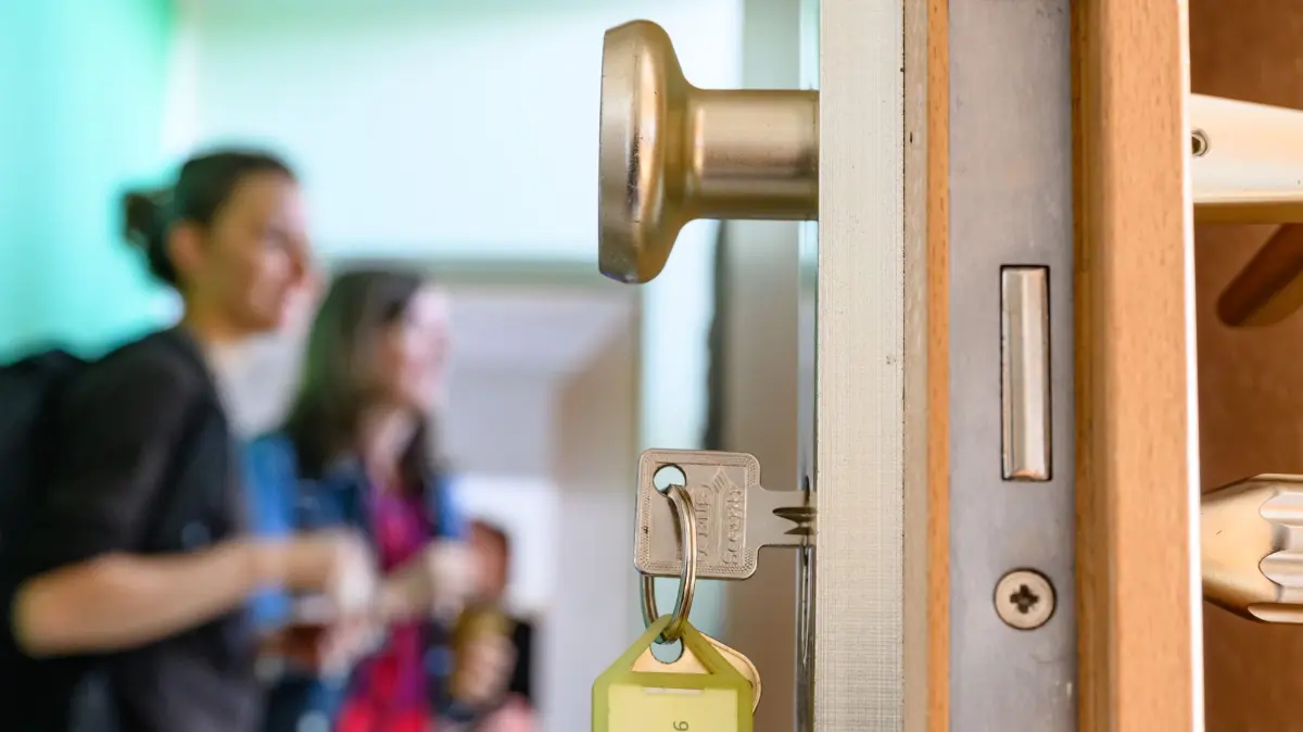 Probewohnen in Eisenhüttenstadt: 08.09.2025, Brandenburg, Eisenhüttenstadt: Ein Schlüssel steckt im Schloss einer Wohnungstür vom Projekt «Jetzt Pläne schmieden - Probewohnen in Eisenhüttenstadt» der Eisenhüttenstädter Gebäudewirtschaft GmbH (GeWi). Am selben Tag gab es eine Pressetermin zum Probewohnen in der Stahlstadt Eisenhüttenstadt. Ausgewählte Teilnehmer können zwei Wochen lang kostenfrei in einer möblierten Wohnung leben und dabei Stadt, Menschen und berufliche Perspektiven im Osten Brandenburgs kennenlernen. Foto: Patrick Pleul/dpa +++ dpa-Bildfunk +++