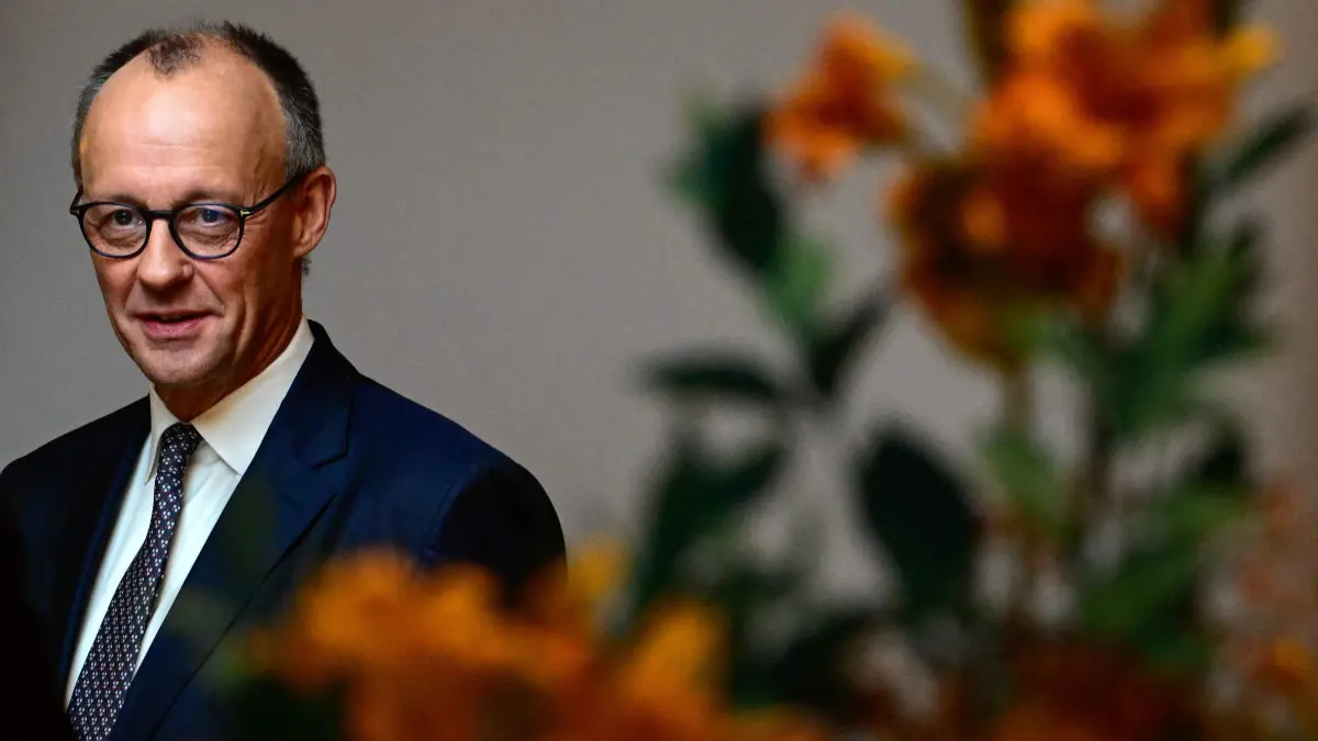 German Chancellor Friedrich Merz poses ffor a pictures before delivering the opening speech at an economic summit hosted by German newspaper Süddeutsche Zeitung at the Adlon Hotel in Berlin on November 17, 2025. (Photo by Tobias SCHWARZ / AFP)