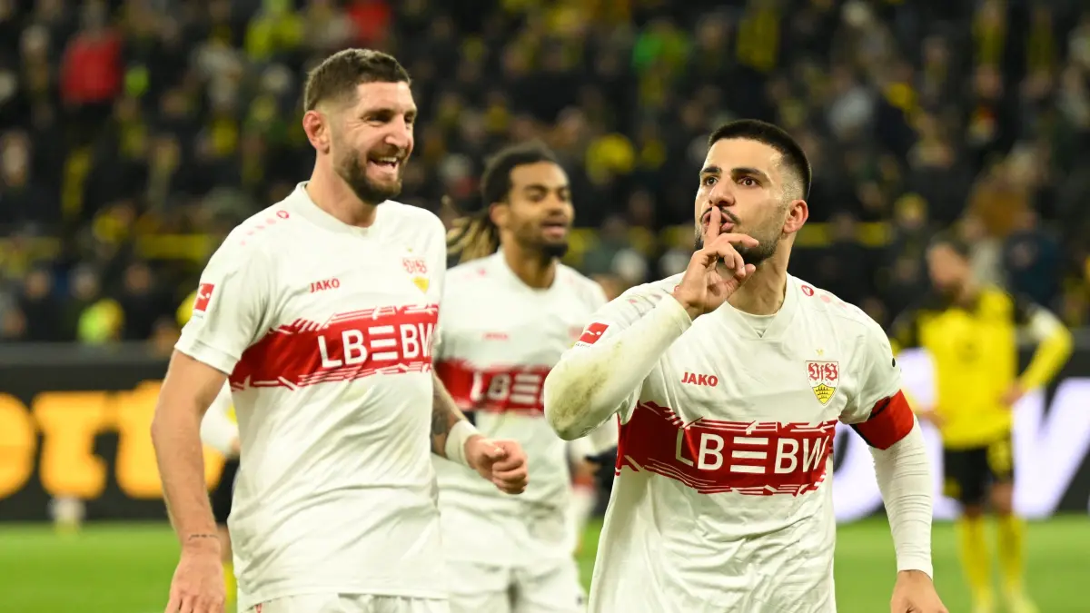 Stuttgart's German forward #26 Deniz Undav (R) celebrates scoring his team's third goal with Stuttgart's German defender #24 Jeff Chabot during the German first division Bundesliga football match between Borussia Dortmund and VfB Stuttgart in Dortmund on November 22, 2025. (Photo by INA FASSBENDER / AFP) / DFL REGULATIONS PROHIBIT ANY USE OF PHOTOGRAPHS AS IMAGE SEQUENCES AND/OR QUASI-VIDEO