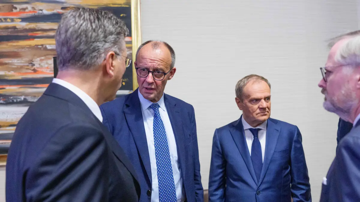 (L-R) Croatia's Prime Minister Andrej Plenkovic, Germany's Chancellor Friedrich Merz, Poland's Prime Minister Donald Tusk and Czech Republic's Prime Minister Petr Fiala talk as they attend a EU meeting at the European Union (EU) - African Union (AU) summit in Luanda, Angola, on November 24, 2025. European and African leaders gather in Angola for a summit to deepen economic and security ties, with emergency talks on Ukraine also on the cards. (Photo by Michael Kappeler / POOL / AFP)