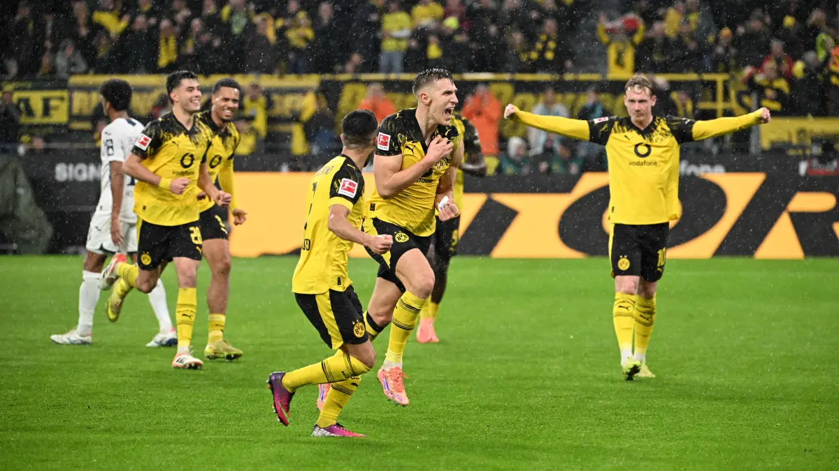 Football: Bundesliga - day 13: Borussia Dortmund v Hoffenheim: Dortmund's German defender #04 Nico Schlotterbeck (2nd R) celebrates with team mates after scoring the 2-0 goal during the German first division Bundesliga football match between BVB Borussia Dortmund and TSG 1899 Hoffenheim in Dortmund, western Germany, on December 7, 2025. (Photo by UWE KRAFT / AFP) / DFL REGULATIONS PROHIBIT ANY USE OF PHOTOGRAPHS AS IMAGE SEQUENCES AND/OR QUASI-VIDEO