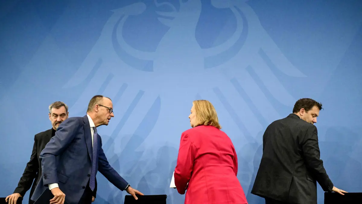 (L-R) Bavaria's State Premier and leader of the conservative Christian Social Union (CSU) Markus Soeder, German Chancellor Friedrich Merz, German Minister for Labour and Social Affairs Baerbel Bas (SPD) and German Finance Minister and Vice Chancellor Lars Klingbeil (SPD) leave after a press briefing on the results of their overnight coalition committee consultations, on December 11, 2025 at the Chancellery in Berlin. (Photo by Tobias SCHWARZ / AFP)