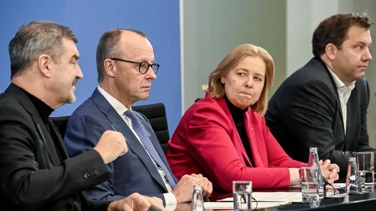 (L-R) Bavaria's State Premier and leader of the conservative Christian Social Union (CSU) Markus Soeder, German Chancellor Friedrich Merz, German Minister for Labour and Social Affairs Baerbel Bas (SPD) and German Finance Minister and Vice Chancellor Lars Klingbeil (SPD) attend a press briefing on the results of their overnight coalition committee consultations, on December 11, 2025 at the Chancellery in Berlin. (Photo by Tobias SCHWARZ / AFP)