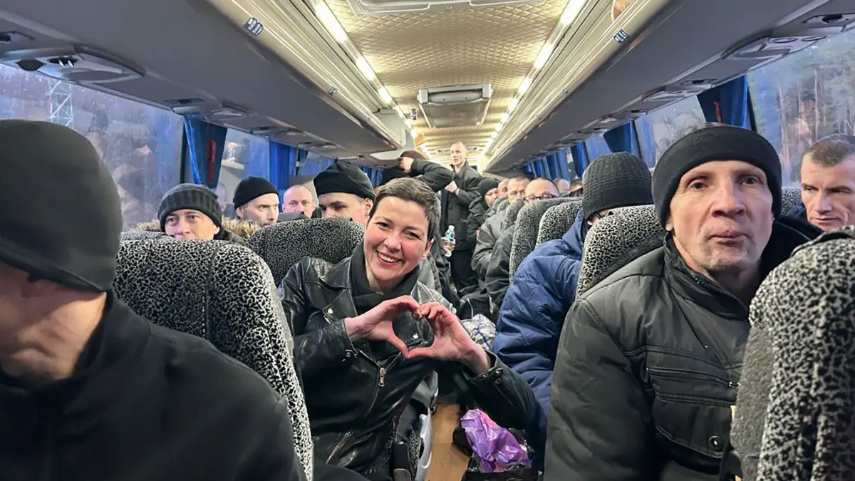 This handout photograph taken and released by the Coordination Headquarters for the Treatment of Prisoners of War on December 13, 2025, shows Maria Kalesnikava (C), a coordinator of Viktar Babaryka's campaign headquarters, making a heart sign with her hands as she sits in a bus among other former prisoners at an undisclosed location in Ukraine. Belarus has freed 123 prisoners, including protest leaders Viktar Babaryka, Maria Kalesnikava, and Nobel Peace Prize laureate Ales Bialiatski, rights groups and state media reported on December 13, 2025, after the US envoy earlier said Washington was lifting sanctions on Belarusian potassium. (Photo by Handout / COORDINATION HEADQUARTERS FOR THE TREATMENT OF PRISONERS OF WAR / AFP) / RESTRICTED TO EDITORIAL USE - MANDATORY CREDIT "AFP PHOTO / COORDINATION HEADQUARTERS FOR THE TREATMENT OF PRISONERS OF WAR" - HANDOUT - NO MARKETING NO ADVERTISING CAMPAIGNS - DISTRIBUTED AS A SERVICE TO CLIENTS - AFP CANNOT INDEPENDENTLY VERIFY THE AUTHENTICITY OR LOCATION, DATE, AND CONTENT OF THESE IMAGES. /