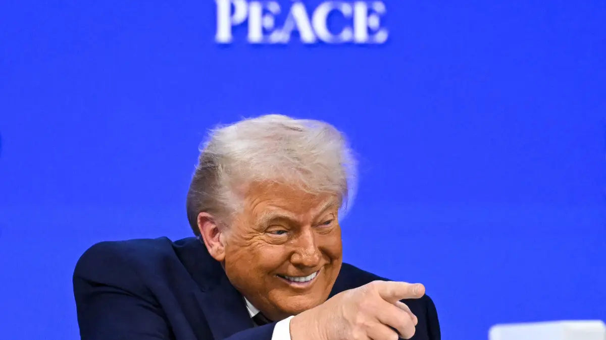 US President Donald Trump gestures as he speaks at the "Board of Peace" meeting during the World Economic Forum (WEF) annual meeting in Davos on January 22, 2026. US President Donald Trump will show off his new "Board of Peace" at Davos on January 22, 2026 burnishing his claim to be a peacemaker a day after backing off his own threats against Greenland. Originally meant to oversee the rebuilding of Gaza after the war between Hamas and Israel, the board's charter does not limit its role to the Strip, and has sparked concerns that Trump wants it to rival the United Nations. (Photo by Fabrice COFFRINI / AFP)