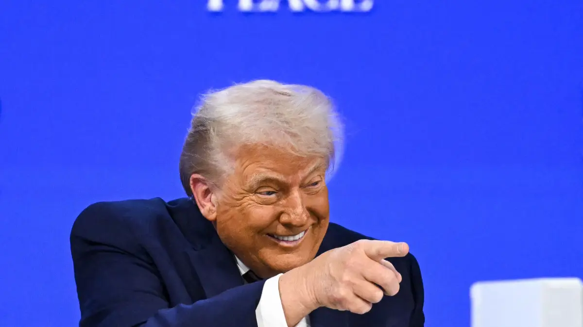 US President Donald Trump gestures as he speaks at the "Board of Peace" meeting during the World Economic Forum (WEF) annual meeting in Davos on January 22, 2026. US President Donald Trump will show off his new "Board of Peace" at Davos on January 22, 2026 burnishing his claim to be a peacemaker a day after backing off his own threats against Greenland. Originally meant to oversee the rebuilding of Gaza after the war between Hamas and Israel, the board's charter does not limit its role to the Strip, and has sparked concerns that Trump wants it to rival the United Nations. (Photo by Fabrice COFFRINI / AFP)