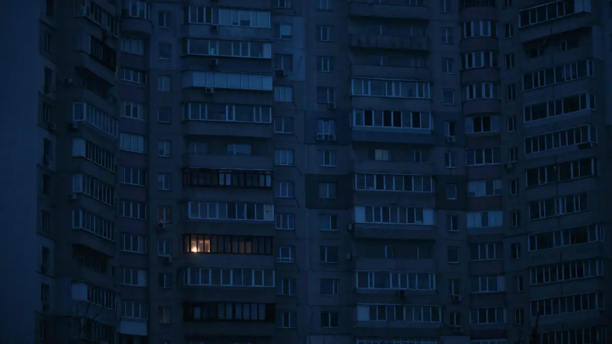 This photograph shows residential buildings during a power outage in Kyiv on January 22, 2026, amid the Russian invasion of Ukraine. (Photo by Sergei GAPON / AFP)