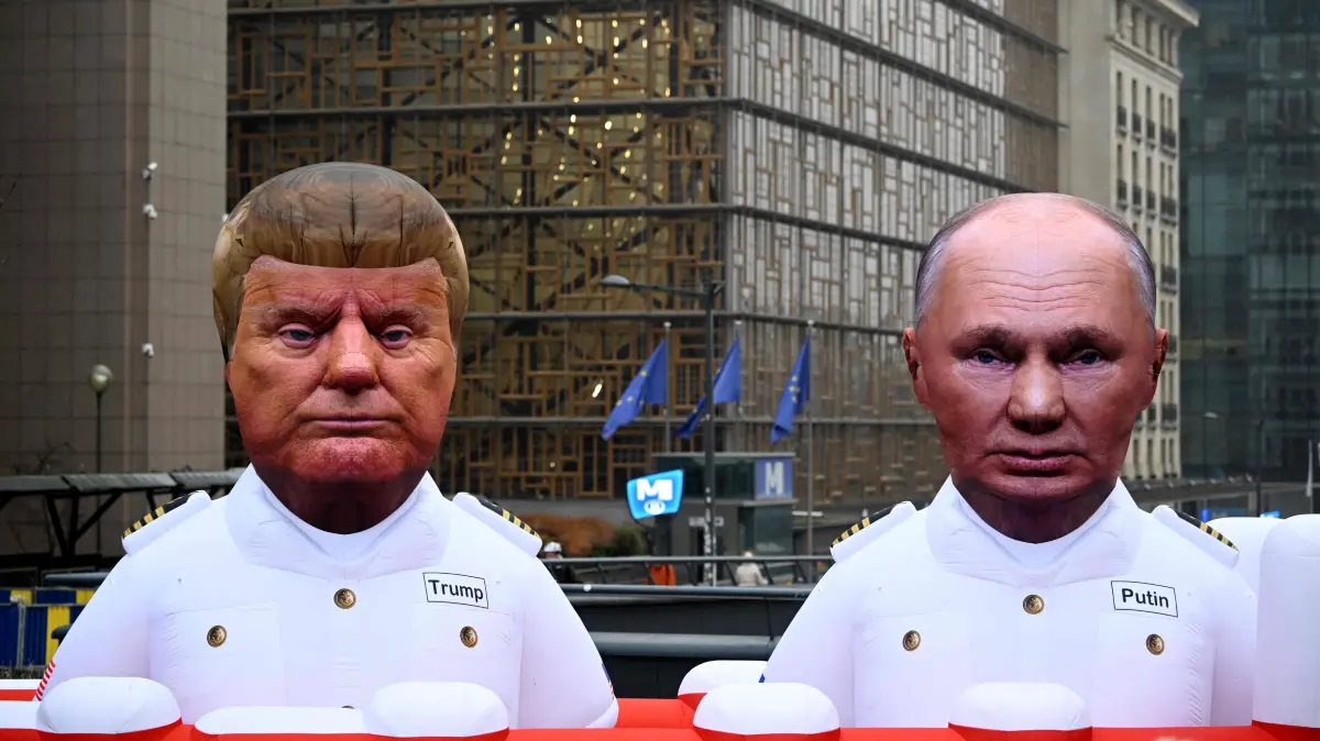 This photograph shows a giant inflatable tanker with balloons in the likeness of US President Donald Trump and Russia's President Vladimir Putin displayed by Greenpeace activists to demonstrate against fossil gas next to the European Council in Brussels on January 26, 2026. As the European Union seeks a ban on Russian gas imports, Greenpeace calls for the EU not to replace Russian gas with gas from the US. (Photo by Nicolas TUCAT / AFP)