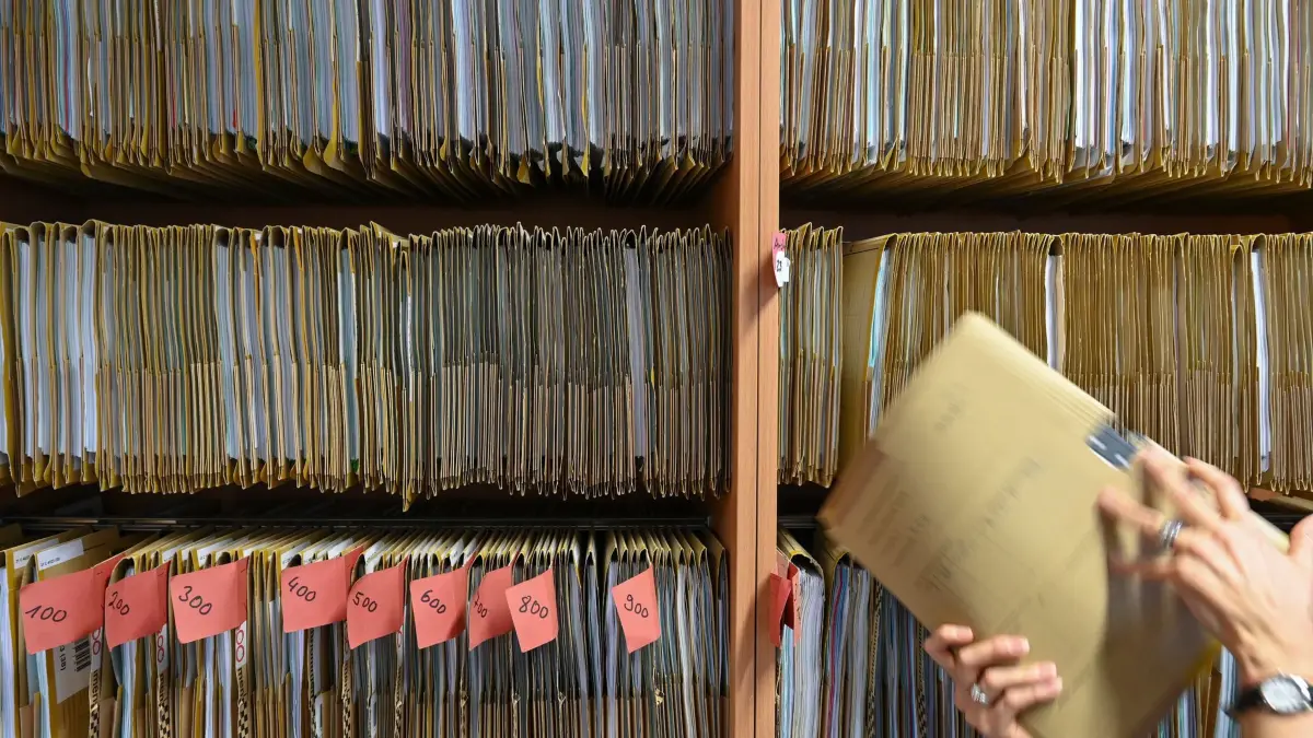 Digitalisierung in der Verwaltung: ARCHIV - 27.07.2023, Hessen, Frankfurt/Main: Eine Mitarbeiterin einer Behörde greift an einem Regal nach einer Akte. (zu dpa: «Bis Ende des Jahres sollen Hunderte Vorschriften wegfallen») Foto: Arne Dedert/dpa +++ dpa-Bildfunk +++