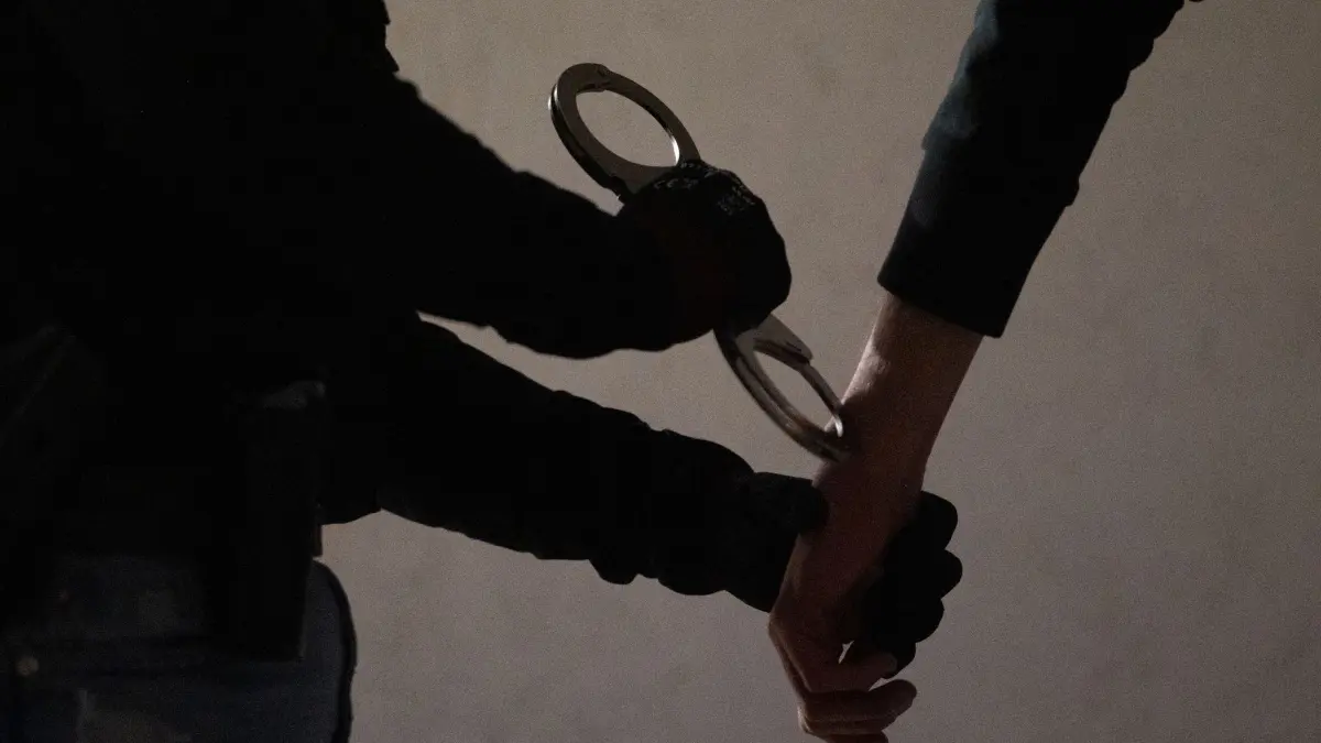 Illustrationen: PRODUKTION - 12.05.2025, Bayern, München: Eine Polizistin legt einem Mann Handschellen an. (zu dpa: «Mann bedroht Mitarbeiter in Supermarkt - Festnahme») Foto: Leonie Asendorpf/dpa +++ dpa-Bildfunk +++