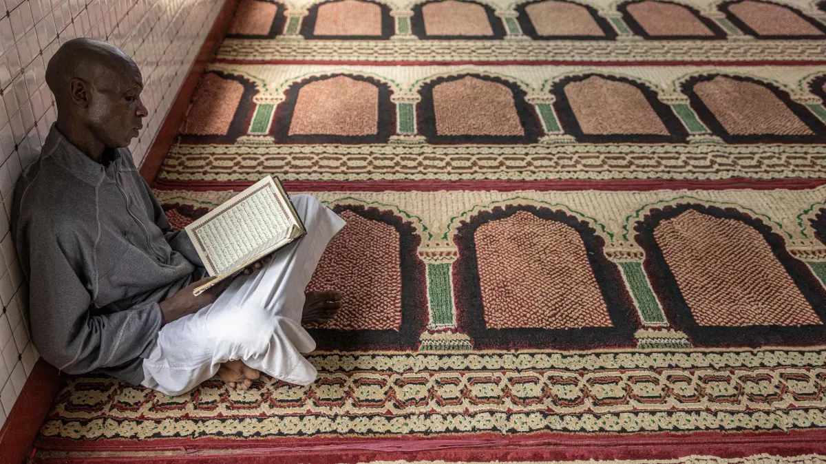 A Muslim worshipper reads from the Quran during the first Friday prayers of the holy month of Ramadan at the Al Maida Mosque Kibera in Nairobi on February 20, 2026. (Photo by SIMON MAINA / AFP)