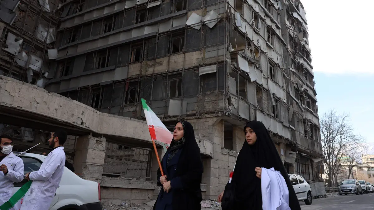 Member of the Iranian medical staff arrive for their protest in front of the destroyed Gandhi Hospital in Tehran on March 7, 2026. The high-end private Gandhi Hospital in northwest Tehran had its windows blown out in the first days of the war, one of 13 hospitals to have sustained damage, according to the World Health Organisation. (Photo by AFP)