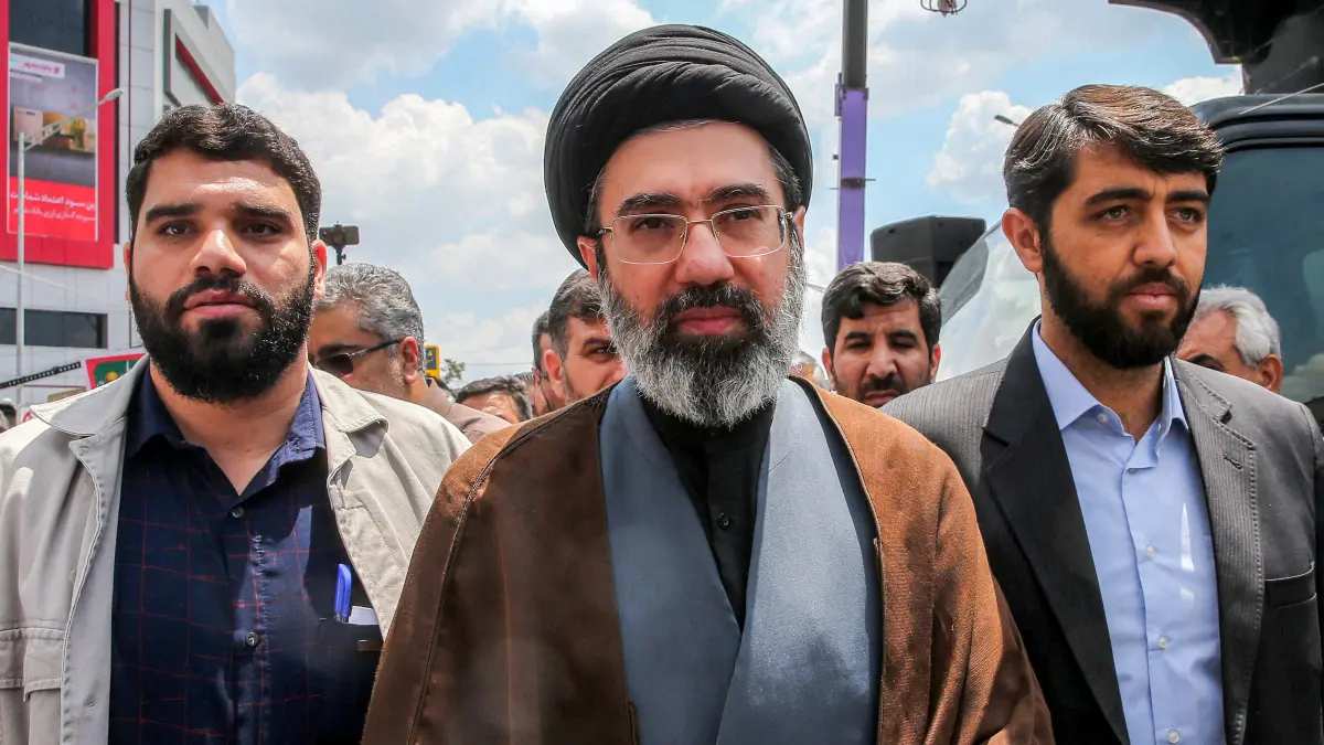 (FILES) In this picture obtained from Iran's ISNA news agency, Mojtaba Khamenei (C), son of Iran's supreme leader Ayatollah Ali Khamenei, walks along a street in Tehran on May 31, 2019. Iran marked the appointment of Ayatollah Mojtaba Khamenei to replace his father as its supreme leader with a new barrage of missiles against Israel and the Gulf states on March 9, 2026, as the Middle East war sent oil prices soaring. (Photo by Hamid FOROUTAN / ISNA / AFP)