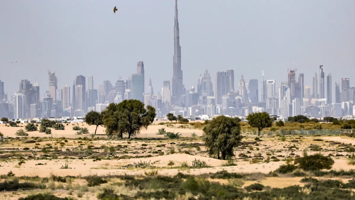 A photograph shows Dubai's skyline with the Burj Khalifa at the centre on March 11, 2026. The Gulf countries have long been seen as islands of stability in the Middle East, but the war in the region could threaten their prosperity, analysts said, pointing to risks to their revenues and reputations as business havens. (Photo by FADEL SENNA / AFP) / Attention editors: AFP covers the war in the Middle East through its extensive regional network, including bureaus in Tehran, Jerusalem, and several neighboring countries. Since the start of the conflict, journalists have been working under increasingly restrictive conditions. Authorities in several countries have limited reporters' movements, photo and live video coverage from sensitive locations. Some governments and armed groups have banned images of missile or drone strikes and other security-related sites. /