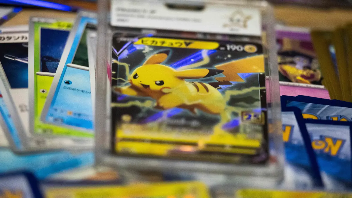 This photograph shows displayed collectible cards from the Pokemon Trading Card Game (TCG) including a mint rated card featuring Pikachu graded by French card grading service PCA at an amateur collector's appartment in Paris on March 11, 2026. Pokemon cards, bearing "little monsters" that attract children as well as adult superfans, have soared in value in recent years. Collecting Pokemon cards has become a form of investment beyond collecting, trading or playing. (Photo by Martin LELIEVRE / AFP)
