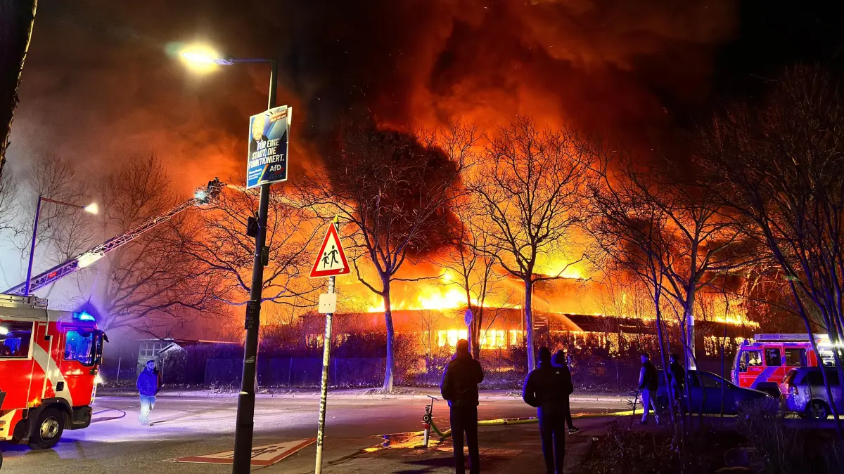 Flammen schlagen aus einer ehemaligen Kita im Berliner Ortsteil Wittenau. Die Feuerwehr ist mit zahlreichen Einsatzkräften im Einsatz, um den Großbrand unter Kontrolle zu bringen.