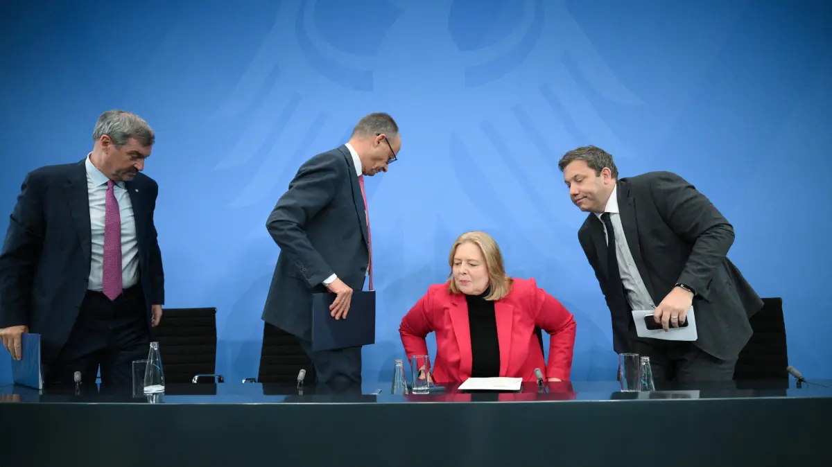 (L-R) Bavaria's State Premier and leader of the conservative Christian Social Union (CSU) Markus Soeder, German Chancellor Friedrich Merz of the conservative Christian Democratic Union (CDU), German Minister for Labour and Social Affairs Baerbel Bas from the social democratic SPD party, and German Finance Minister and Vice Chancellor Lars Klingbeil (SPD) leave after a press briefing on the results of overnight coalition committee consultations, on April 13, 2026 at the Chancellery in Berlin. Chancellor Friedrich Merz said that Germany would cut petrol and diesel taxes for two months to provide relief to households and businesses hit by the energy shock during the Middle East war. (Photo by RALF HIRSCHBERGER / AFP)