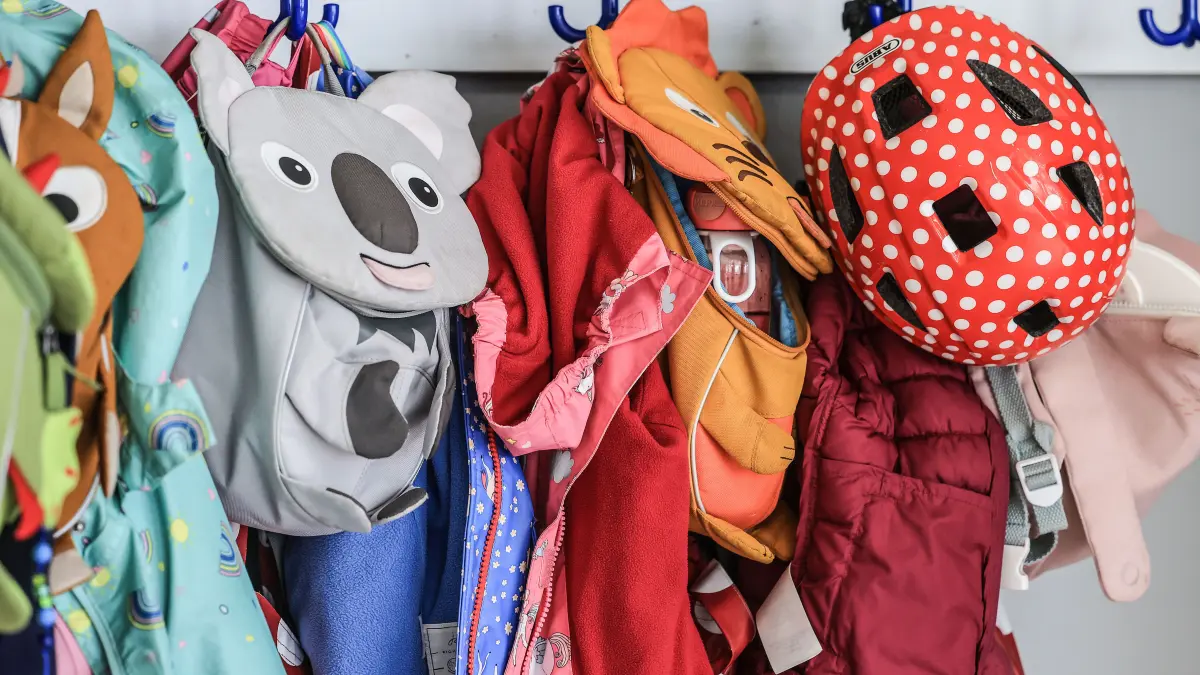 Garderobe und Taschen von Kindern hängen im Flur einer Kindertagesstätte. Alltagshelferin Philipp hilft in der Kita der Diakonie an der Duisburger Straße in Düsseldorf. (Zu dpa/lnw: „Alltagshelfer in Kitas: «Erfahren oft erst am ersten Arbeitstag, ob der Vertrag verlängert wurde»“) +++ dpa-Bildfunk +++
