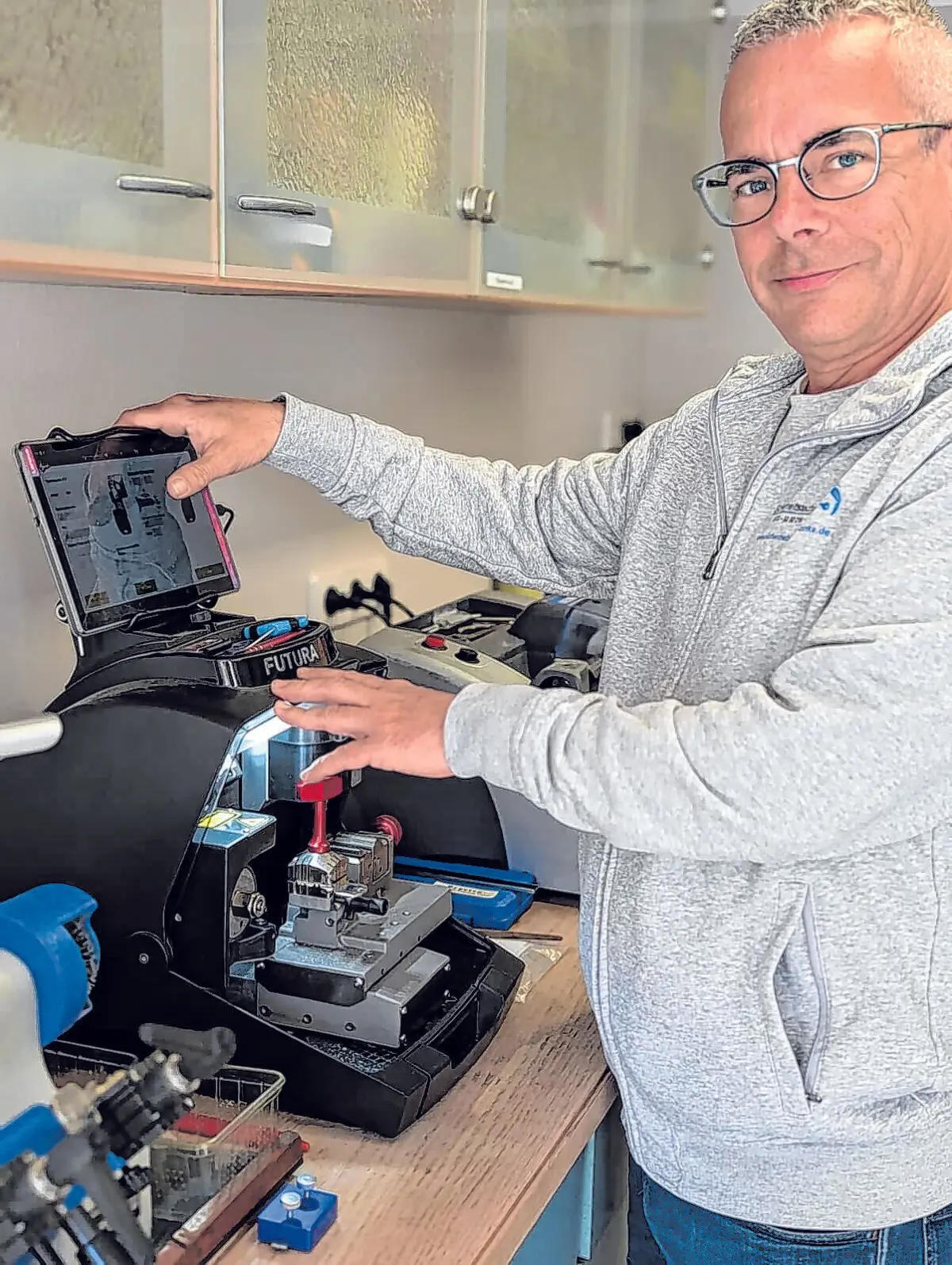 Jörn Zinke arbeitet an einer modernen Maschine zur Anfertigung und Programmierung von Schlüsseln und Schließsystemen.