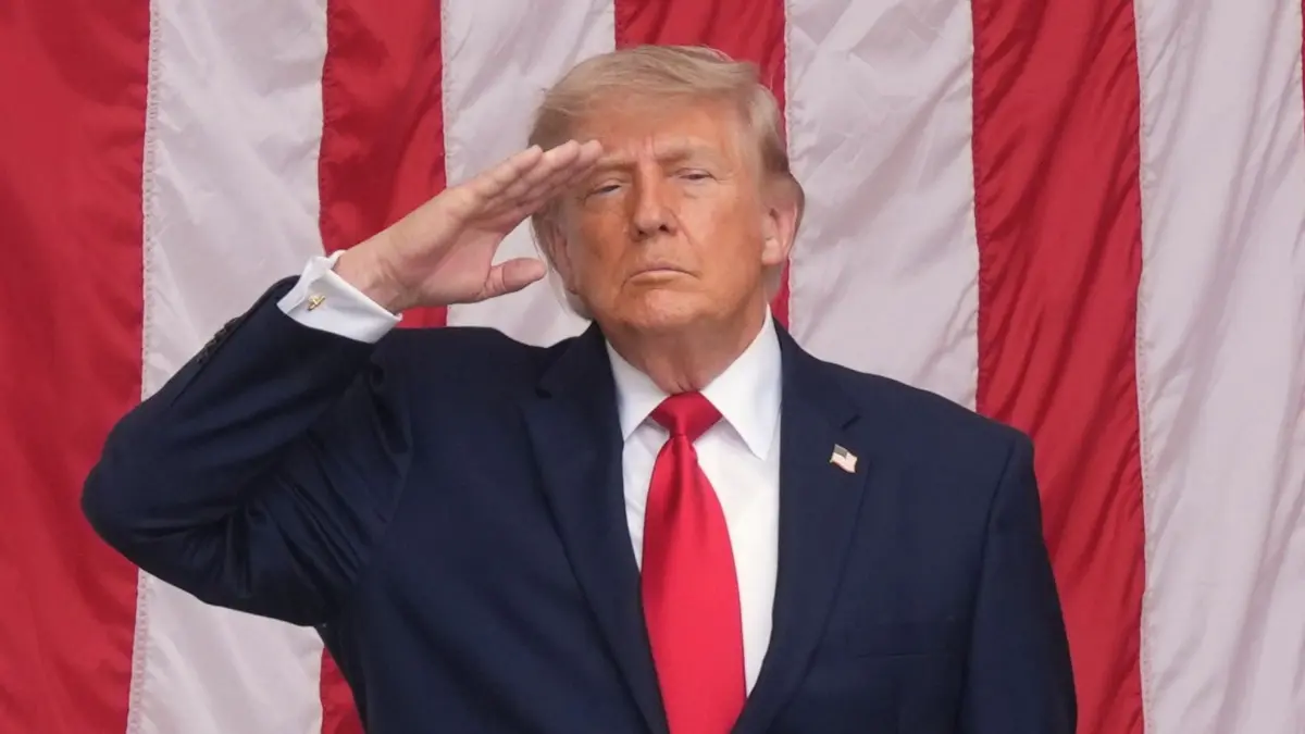 Nationaler US-Feiertag Memorial Day: 25.05.2026, USA, Arlington: US-Präsident Donald Trump salutiert während des Abspielens von «Taps» bei einer Zeremonie am Memorial Day auf dem Arlington National Cemetery. Der Memorial Day fällt mit den Feierlichkeiten zum 250-jährigen Bestehen der USA zusammen. Foto: Alex Brandon/AP/dpa +++ dpa-Bildfunk +++