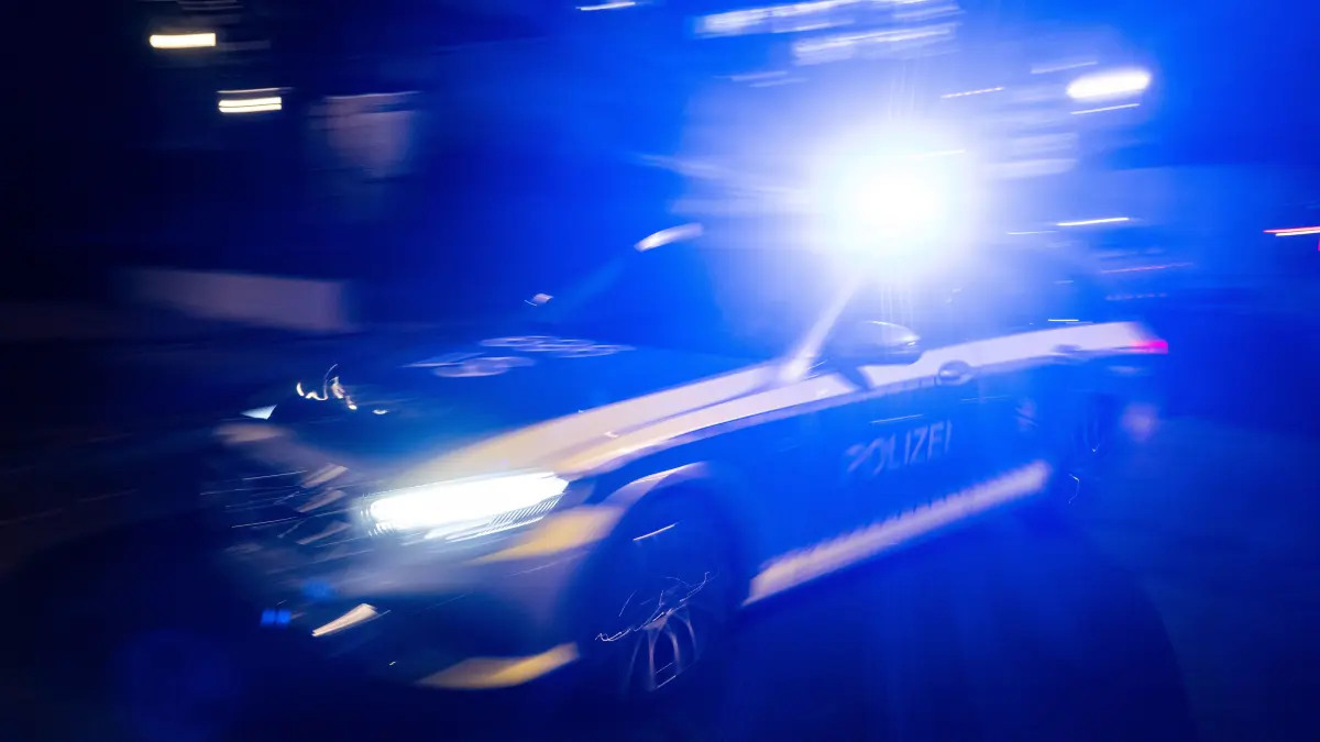 ILLUSTRATION - 30.11.2023, Baden-Württemberg, Stuttgart: Ein Polizeifahrzeug fährt mit Blaulicht an einem Gebäude vorbei. (zu dpa: «Polizei nimmt Autofahrer nach Verfolgungsjagd fest») Foto: Marijan Murat/dpa +++ dpa-Bildfunk +++