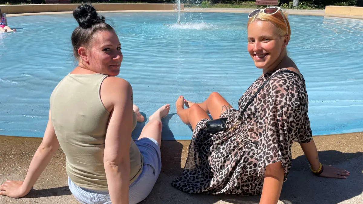 Sandra und Jana aus Fürstenwalde lassen es sich im Stadtpark gut gehen. Am Springbrunnen genießen sie das sonnige Wetter und trotzen den Temperaturen von teilweise über 30 °Celsius.