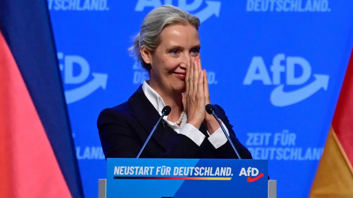 GERMANY-POLITICS-PARTIES-FAR RIGHT-AFD: Co-leader of the far-right Alternative for Germany (AfD) party Alice Weidel acknowledges applaud by the delegates after delivering a speech at the party congress of far-right Alternative for Germany (AfD) at the Messe Erfurt fairground in Erfurt, eastern Germany on July 4, 2026. About 20,000 people flocked to Erfurt, in Thuringia state, according to police, to protest against the Alternative for Germany (AfD) party that tops national opinion polls. (Photo by John MACDOUGALL / AFP)