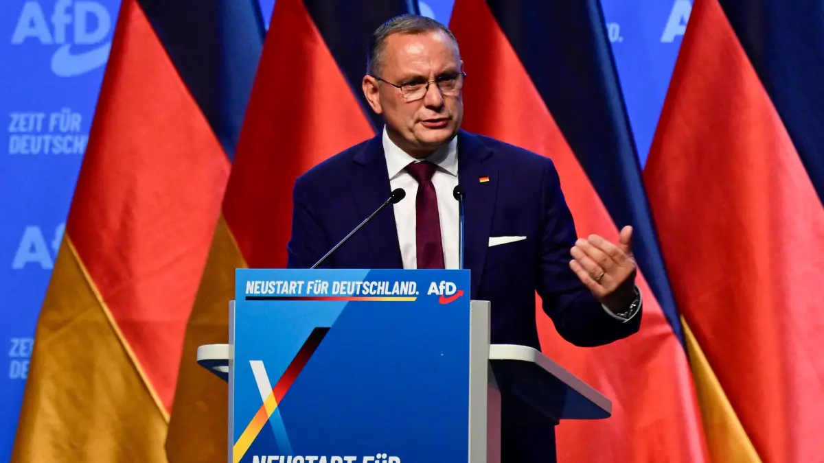 GERMANY-POLITICS-PARTIES-FAR RIGHT-AFD: Co-leader of the far-right Alternative for Germany (AfD) party Tino Chrupalla addresses delegates as he candidates as the party's co-chairman at the party congress of far-right Alternative for Germany (AfD) at the Messe Erfurt fairground in Erfurt, eastern Germany on July 4, 2026. About 20,000 people flocked to Erfurt, in Thuringia state, according to police, to protest against the Alternative for Germany (AfD) party that tops national opinion polls. (Photo by John MACDOUGALL / AFP)