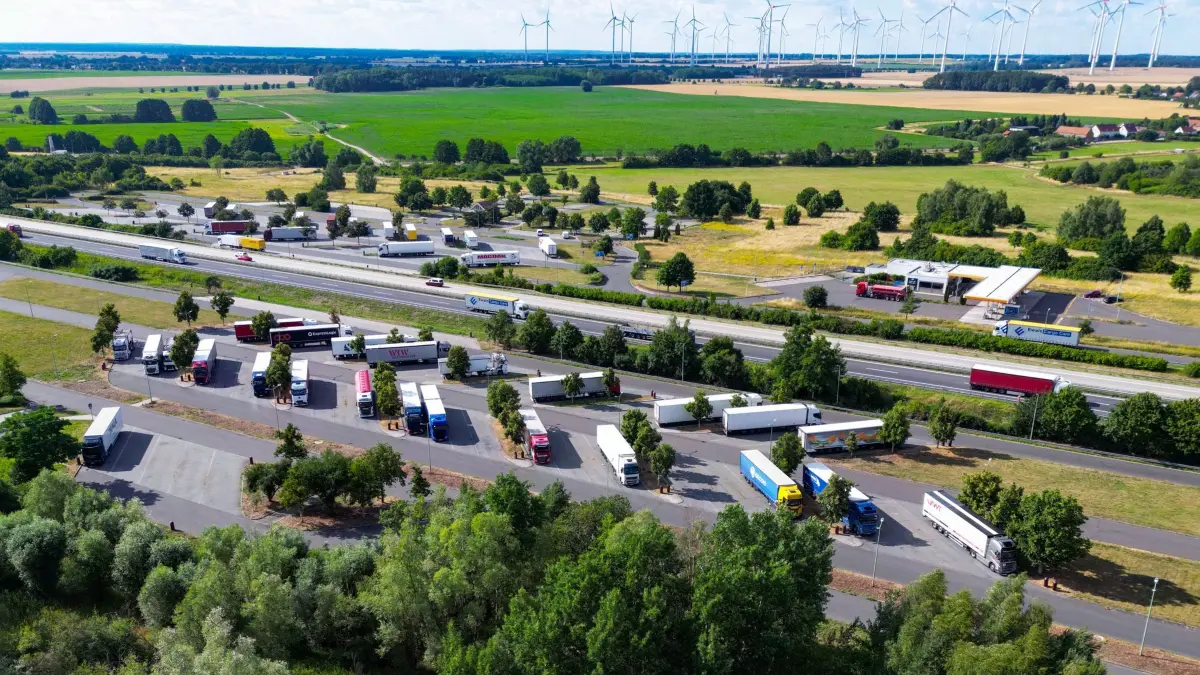 Kriminalität: Organisierte Lkw-Banden schlagen auf Rastplätzen: ARCHIV - 09.07.2026, Brandenburg, Biegen: Lkw stehen auf einem Rastplatz an der Autobahn A12 (Luftaufnahme mit einer Drohne). In Brandenburg kommt es auf Autobahn-Rastplätzen regelmäßig zu organisierten Lkw-Aufbrüchen, Ladungsdiebstählen und Raubüberfällen durch bandenmäßig organisierte Kriminelle. Besonders betroffen sind die unbeleuchteten oder unbewachten Parkplätze entlang des Berliner Rings A10 sowie der A11 und A12. (zu dpa: «Gefahr auf Autobahn-Rastplatz - Lkw-Diebe schlagen wieder zu») Foto: Patrick Pleul/dpa +++ dpa-Bildfunk +++