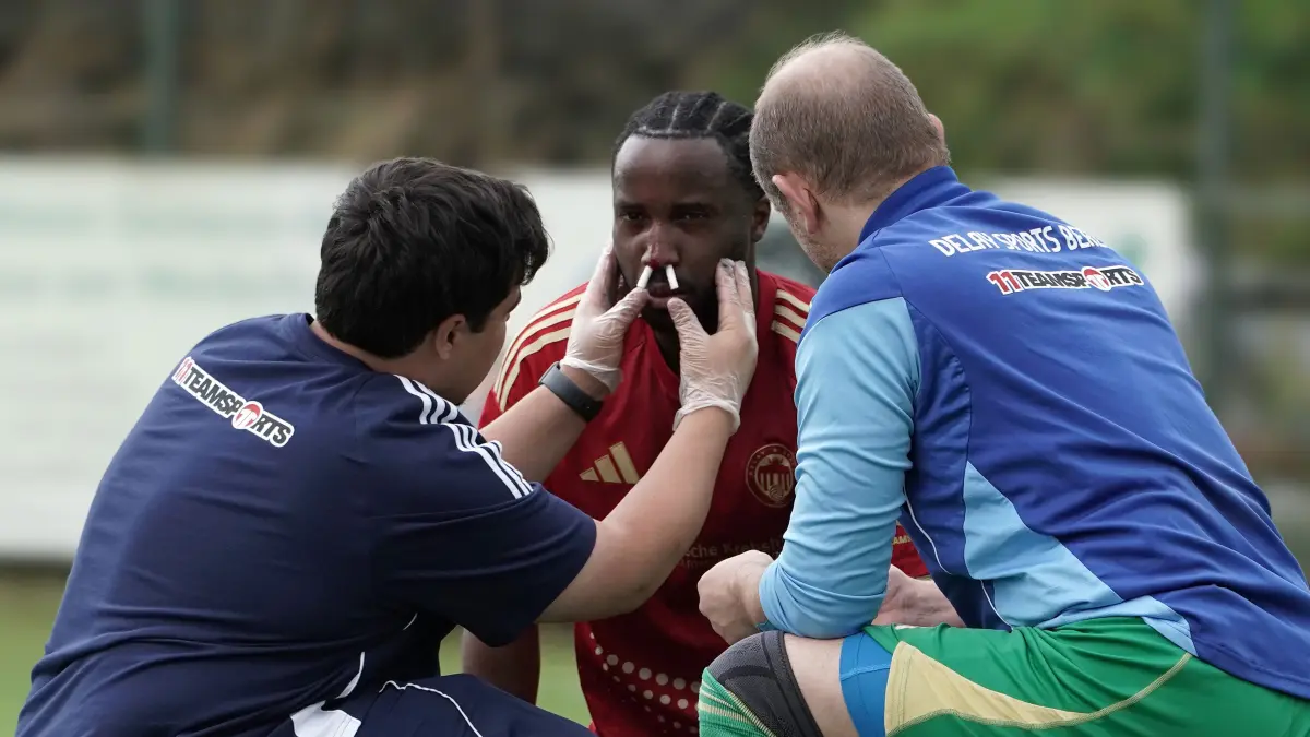 Fussball : Klosterfelde, Fussball Freundschaftsspiele Deutschland / Regional, Union Klosterfelde : Delay Sports Berlin, vom Spielfeld ins Krankenhaus Eberswalde mit einer Nasenbeinfraktur, Torschütze Panzu Ernesto De Angelo hier noch behandelt von Physioterapeuthen Hakki Eder, der Torschütze verletzte sich bei einen Klärungsversuch mit dem Kopf und wurde dabei von einen Unioner getroffen, ETW Maximilian Wesel r.
FOTO BENK 18.07.2026