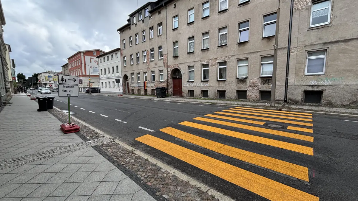 Dank eines knallorangefarbenen Zebrastreifens konnten zuletzt Fußgänger bequem die Grabowstraße überqueren. Der Zebrastreifen ist aber schon wieder weg. Was ist der Grund für diese Arbeiten? Aufnahme vom 23. Juli 2026.