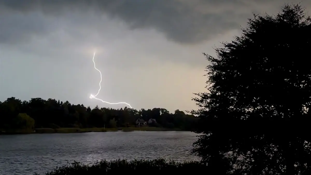 Unwetter in Schleswig-Holstein: ARCHIV - 27.06.2026, Schleswig-Holstein, Kosel: Ein Blitz zuckt während eines Unwetters über dem Langsee in der Nähe von Eckernförde. Nach den hochsommerlichen Temperaturen vom Tag hat ein Gewitter mit Starkregen und Sturm am Abend für Abkühlung gesorgt. (zu dpa: «Gewitter und Starkregen auch am Freitag im Norden möglich») Foto: Daniel Bockwoldt/dpa +++ dpa-Bildfunk +++