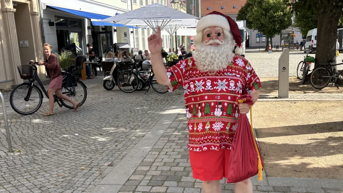 Neuruppiner Santa steht im August auf dem Schulplatz in Neuruppin